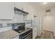 Updated kitchen with white cabinetry, granite counters, and stainless steel appliances at 3202 W Glenrosa Ave, Phoenix, AZ 85017