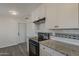 Well-lit kitchen with granite countertops, white cabinets, and black appliances at 3202 W Glenrosa Ave, Phoenix, AZ 85017