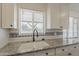 Kitchen sink featuring granite countertops, white cabinets, and a window with natural light at 3202 W Glenrosa Ave, Phoenix, AZ 85017