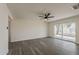 Large living room with sliding glass doors and grey wood flooring at 3202 W Glenrosa Ave, Phoenix, AZ 85017