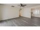 Open living room with grey wood flooring and ample natural light at 3202 W Glenrosa Ave, Phoenix, AZ 85017