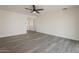 Spacious living room with grey wood flooring, ceiling fan and bright natural light at 3202 W Glenrosa Ave, Phoenix, AZ 85017