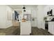 Modern kitchen with white cabinetry, stainless steel appliances, and a convenient island with seating at 32452 N Cherry St, San Tan Valley, AZ 85143