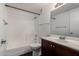Well-lit bathroom featuring a shower over tub and a dark wood vanity with sink at 3434 E Baseline Rd # 216, Phoenix, AZ 85042