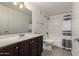 Well-lit bathroom with neutral colored tiles, modern vanity, and shower over tub at 3434 E Baseline Rd # 216, Phoenix, AZ 85042