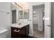 This well-lit bathroom includes a modern vanity, a mirror, and an open doorway at 3434 E Baseline Rd # 216, Phoenix, AZ 85042