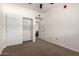 This carpeted bedroom includes a closet and an open door to the en suite bathroom at 3434 E Baseline Rd # 216, Phoenix, AZ 85042