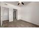 Carpeted bedroom with a ceiling fan and access to a spacious closet at 3434 E Baseline Rd # 216, Phoenix, AZ 85042