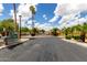 Gated community entrance with well-maintained landscaping, showcasing a secure and private residential environment at 3434 E Baseline Rd # 216, Phoenix, AZ 85042