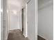 Bright hallway with carpet, neutral walls, and access to storage with wire shelving at 3434 E Baseline Rd # 216, Phoenix, AZ 85042