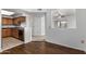 View of kitchen and dining room area with wood floors and neutral carpeting at 3434 E Baseline Rd # 216, Phoenix, AZ 85042