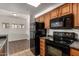 Kitchen with black appliances and abundant cabinet storage adjacent to separate dining area at 3434 E Baseline Rd # 216, Phoenix, AZ 85042