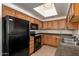 Bright kitchen with black appliances, ample cabinetry, and a skylight for natural light at 3434 E Baseline Rd # 216, Phoenix, AZ 85042