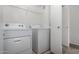 A well-lit laundry room with modern washer and dryer units, and wire shelving at 3434 E Baseline Rd # 216, Phoenix, AZ 85042