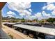 Wide view of the community parking area with covered parking spaces in a well-maintained complex and desert landscape at 3434 E Baseline Rd # 216, Phoenix, AZ 85042