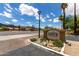 A community sign amidst desert landscaping, marking the entrance to Raven Condominiums at 3434 E Baseline Rd # 216, Phoenix, AZ 85042