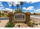 Close up of the Raven Condominiums community sign, surrounded by desert landscaping, with building peeking from the side at 3434 E Baseline Rd # 216, Phoenix, AZ 85042