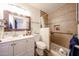 Bright bathroom featuring a shower with a grab bar and a vanity with a decorative framed mirror at 3608 W Villa Rita Dr, Glendale, AZ 85308