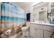 Bathroom with white cabinets, a beach-themed shower curtain, and tile flooring at 3608 W Villa Rita Dr, Glendale, AZ 85308