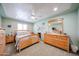 Bedroom featuring soft green walls, light wood furniture, and ceiling fan at 3608 W Villa Rita Dr, Glendale, AZ 85308