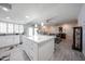 Well-lit kitchen with a white island, stainless steel appliances, and seamless transition to dining area at 3608 W Villa Rita Dr, Glendale, AZ 85308