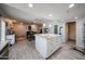 Open kitchen featuring a central island with white cabinets and view of the dining area at 3608 W Villa Rita Dr, Glendale, AZ 85308
