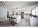 Bright kitchen featuring an island with barstool seating, stainless appliances, and white cabinetry at 3608 W Villa Rita Dr, Glendale, AZ 85308