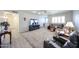 Bright living room with multiple seating options, contemporary decor, and a large TV at 3608 W Villa Rita Dr, Glendale, AZ 85308