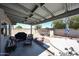 Large covered patio with seating and an outdoor kitchen area, perfect for entertaining or relaxing at 3608 W Villa Rita Dr, Glendale, AZ 85308
