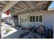 Shaded patio with comfortable seating and convenient access to the house via French doors and large windows at 3608 W Villa Rita Dr, Glendale, AZ 85308