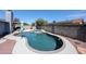 Backyard pool and spa area features privacy walls, gravel landscaping, solar panels, and nearby covered patio at 3608 W Villa Rita Dr, Glendale, AZ 85308