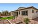 Landscaped backyard featuring a low-maintenance desert design, small lawn, and charming home exterior at 3858 E Kenley Ln, San Tan Valley, AZ 85143