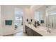 Bathroom with double vanity, a large mirror, and a view into the adjacent bedroom at 3858 E Kenley Ln, San Tan Valley, AZ 85143