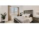 Cozy bedroom with a plush bed, neutral tones, and natural light from the window at 3858 E Kenley Ln, San Tan Valley, AZ 85143