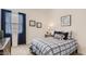 Cozy bedroom featuring a queen-size bed, soft carpet, and natural light from the window with blue curtains at 3858 E Kenley Ln, San Tan Valley, AZ 85143
