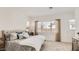 Comfortable bedroom with soft carpeting, large windows, and stylish neutral-toned decor at 3858 E Kenley Ln, San Tan Valley, AZ 85143