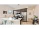 Modern kitchen with an island, stainless steel appliances, and dark wood cabinetry for a sleek look at 3858 E Kenley Ln, San Tan Valley, AZ 85143