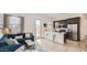 Open-concept living room and kitchen with stainless steel appliances and a comfortable blue sofa at 3858 E Kenley Ln, San Tan Valley, AZ 85143