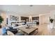 Spacious open living area with modern decor, seamlessly connecting to a kitchen and dining area at 3858 E Kenley Ln, San Tan Valley, AZ 85143