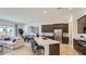 Bright, open floor plan featuring a stylish kitchen with an island overlooking the cozy living area at 3858 E Kenley Ln, San Tan Valley, AZ 85143