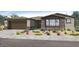 Charming single-Gathering home boasts stone accents, desert landscaping, and a two-car garage at 39640 N Kaden Ln, San Tan Valley, AZ 85140