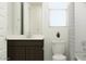 Well-lit bathroom with a dark vanity, white countertop, and matching neutral finishes at 4571 E French Rd, San Tan Valley, AZ 85143