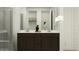 Bathroom with a dual sink vanity, marble shower, and decorative accents at 4571 E French Rd, San Tan Valley, AZ 85143