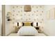 A tranquil bedroom space featuring a queen bed, nightstands, and whimsical floral wallpaper at 4571 E French Rd, San Tan Valley, AZ 85143