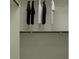 Organized walk-in closet with hanging rods for clothing storage at 4571 E French Rd, San Tan Valley, AZ 85143