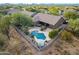 Aerial view of a private backyard oasis with a pool, spa, and beautifully landscaped yard at 5077 E Lonesome Trl, Cave Creek, AZ 85331