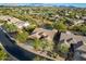 Aerial shot of the property showcasing the pool, surrounding neighborhood, and mountain views in the distance at 5077 E Lonesome Trl, Cave Creek, AZ 85331