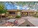 Spacious backyard with a dining area, lush landscaping, and an outdoor kitchen at 5077 E Lonesome Trl, Cave Creek, AZ 85331