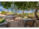 Charming backyard patio with outdoor seating, lush landscaping, and a view of the pool at 5077 E Lonesome Trl, Cave Creek, AZ 85331