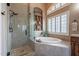 Luxurious bathroom with a soaking tub, walk-in shower, and stylish fixtures at 5077 E Lonesome Trl, Cave Creek, AZ 85331